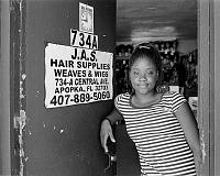  Shakari at the front door of her family's wig shop.